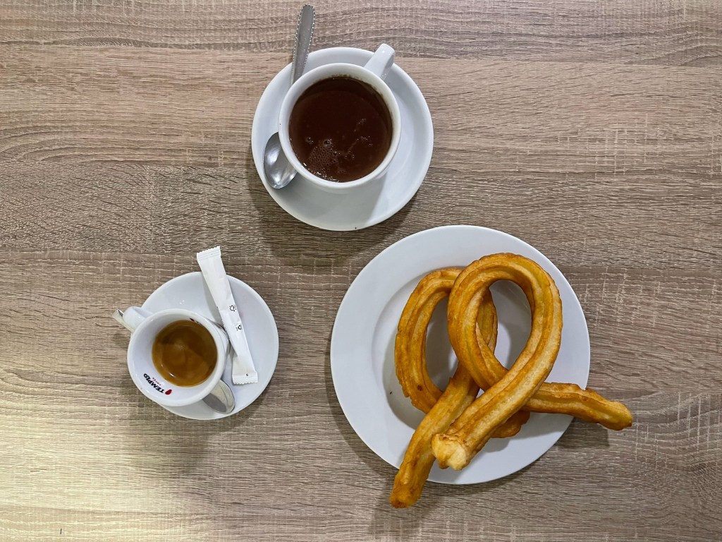 A plate of churro, a café solo, and a cup of hot chocolate at Bar El Comercio in Seville.