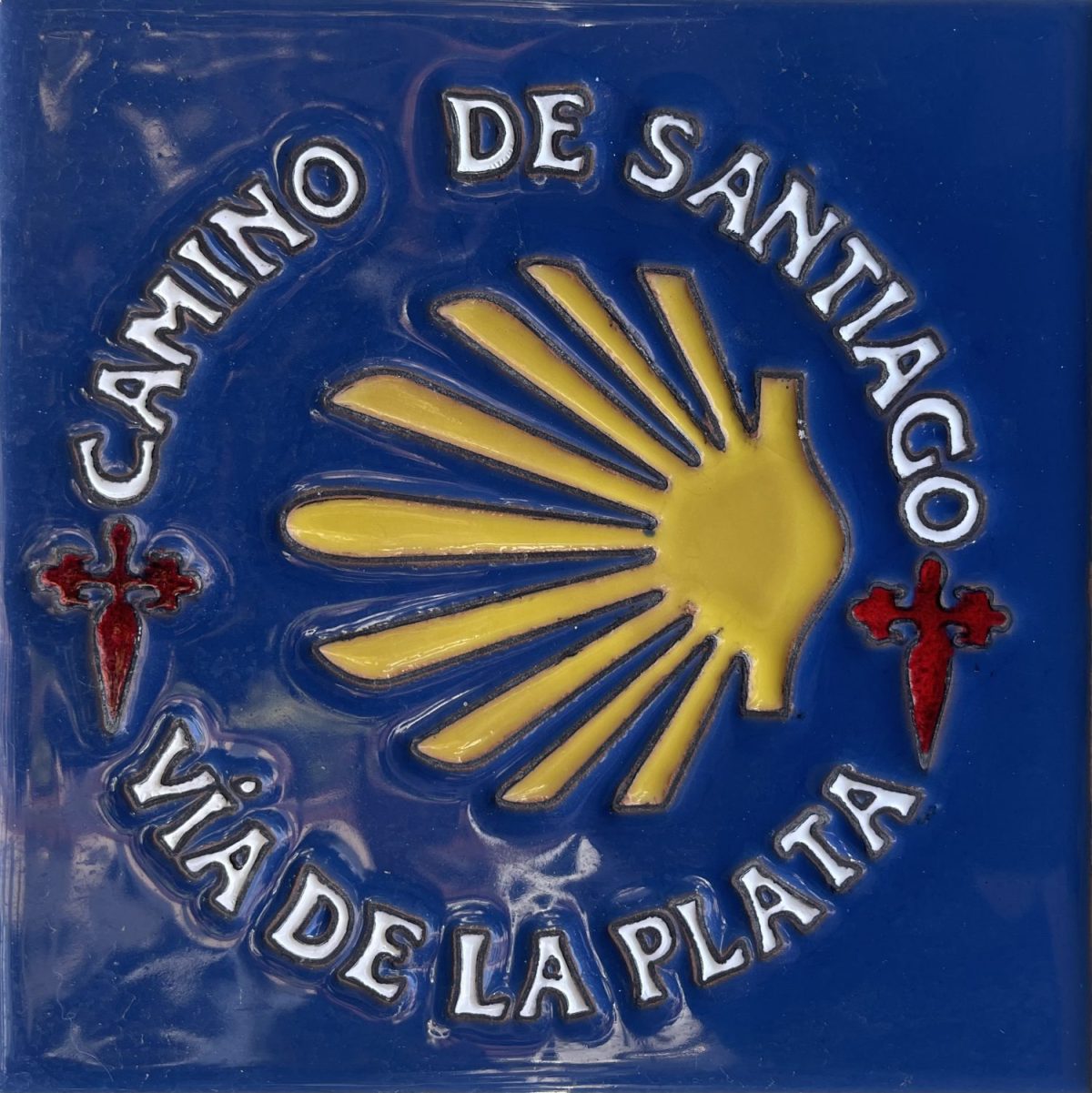 Glazed tile depicting the Via de la Plata symbol on the Camino de Santiago in Spain.