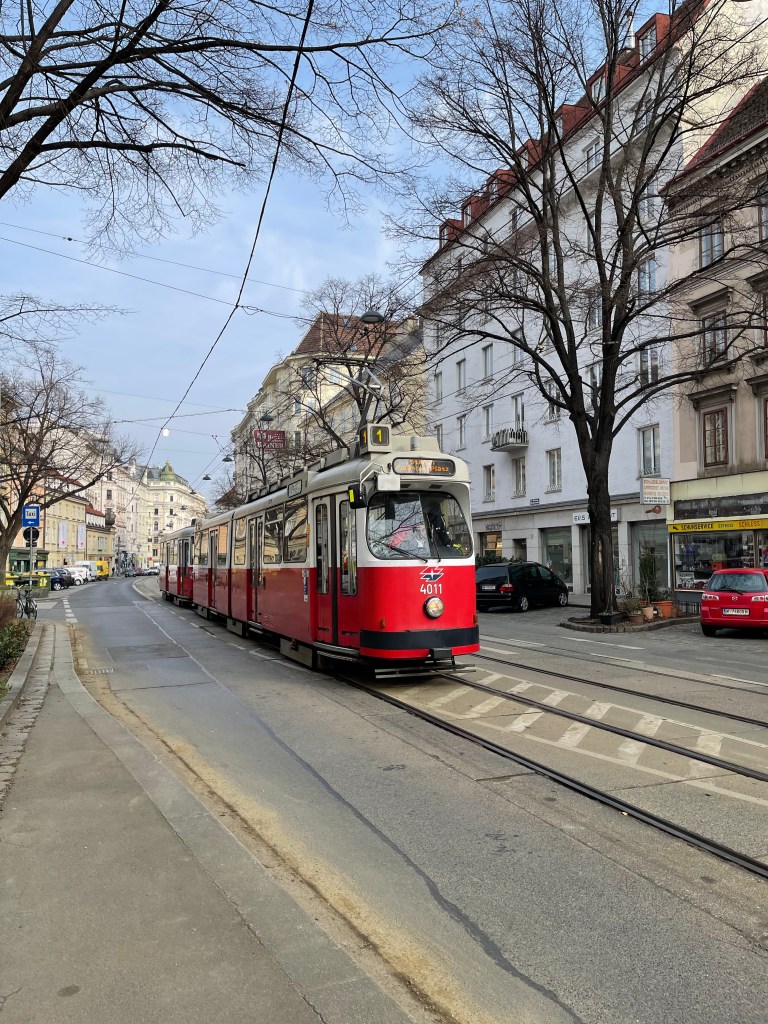 A red and white number 1 tram in Vienna, Austria.