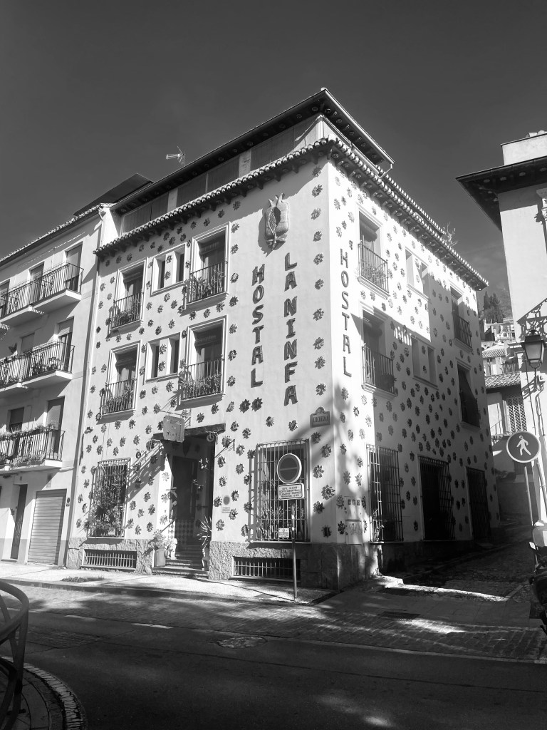 A street view of Hostal La Ninfa in Granada, Spain.